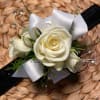 White rose wrist corsage with white ribbon on a black band