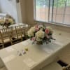 Pink and white floral centerpieces on a decorated banquet table