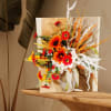 Bright orange and red floral arrangement with white accents in a decorative display