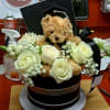 Elegant black velvet hatbox featuring premium white roses and a cuddly plush