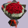 Bouquet of red roses with white baby's breath wrapped in black paper