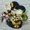 A stylish black heart-shaped box featuring a luxury gold-rimmed mug, a mini