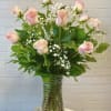Beautiful roses in pink, designed in a clear glass vase complete with