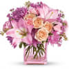 Pink lilies and roses in a pink glass vase