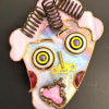 A quirky stained-glass face mask that reads like wearable folk art -
