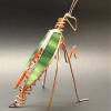 A whimsical glass-and-wire insect that delights at first glance, this small sculptural