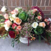 Mixed bouquet with roses, hydrangeas, and apples in a white vase