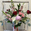 Mixed bouquet of pink and red roses in a striped vase