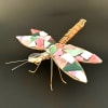A playful, handcrafted dragonfly accent that brings warm, autumnal color to any