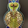  A playful metal and glass owl arrangement that doubles as a