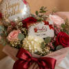 Birthday bouquet with roses, hydrangea, and a balloon