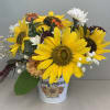 Sunflower bouquet in a white tin container with mixed accent flowers