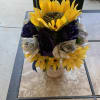 Bright yellow sunflowers steal the show in this cheerful sunflower arrangement for