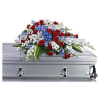 Red, white, and blue floral spray on a silver casket