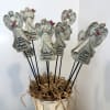 Angel figurines with cardinal accents in a white container