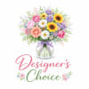 Mixed bouquet of roses, daisies, and sunflowers in a glass vase with a ribbon
