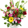Mixed bouquet in a white vase with roses, lilies, and daisies