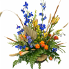 Blue and orange floral arrangement with tall stems in a low container