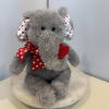 Gray plush elephant with red heart ribbon on a round base