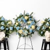 Blue and cream floral wreaths and arrangements on stands and stools