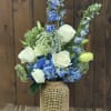 Blue and white floral arrangement in a woven vase