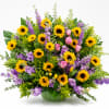 Large bouquet of sunflowers and purple flowers in a green vase