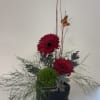 Bold, modern, and effortlessly stylish, Urban Bloom features two vibrant red gerbera