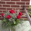 Half a dozen red roses in a clear glass vase to say