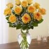 Yellow roses arranged in a clear glass vase with baby's breath