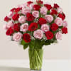 Bouquet of red and pink roses in a clear glass vase