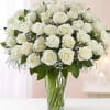 Bouquet of white roses in a clear glass vase
