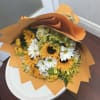 Bouquet of sunflowers and white daisies wrapped in orange paper