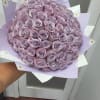 Large bouquet of lavender roses wrapped in pastel paper