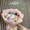 Pastel mixed flower bouquet wrapped in pink paper with ribbon