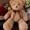 A cuddly plush centerpiece makes a playful twist on a classic gift