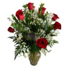 Red roses and white baby's breath in a clear glass vase