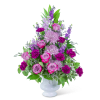 Pink and purple flower arrangement in a white vase