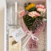 Gift box with a small bouquet, glass vase, and chocolate truffles