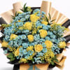 Bouquet of yellow roses and blue daisies wrapped in black and gold paper