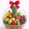 Fruit basket with bananas, apples, grapes, pineapple, pear, and kiwi wrapped in cellophane