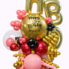 Gold 50th birthday balloon arrangement with pink and black accents