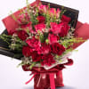 Bouquet of pink and red roses wrapped in black and red paper