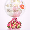 Birthday balloon over pink and white roses with chocolates in a floral box