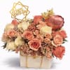 Peach and cream roses in a gift box with a birthday topper and crown