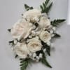 Cream rose bouquet with white filler flowers and ribbon accents