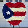 Heart-shaped floral display in red, white, and blue with a star accent