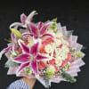 Velvety pink and ivory roses mingle with large pink-and-white oriental lilies in