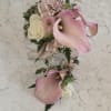 A delicate pairing of mini calla lilies, and roses makes this prom