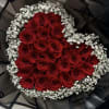 Heart-shaped bouquet of red roses with white baby's breath