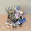 Gift basket with pastel flowers, tea, soap, and chocolate